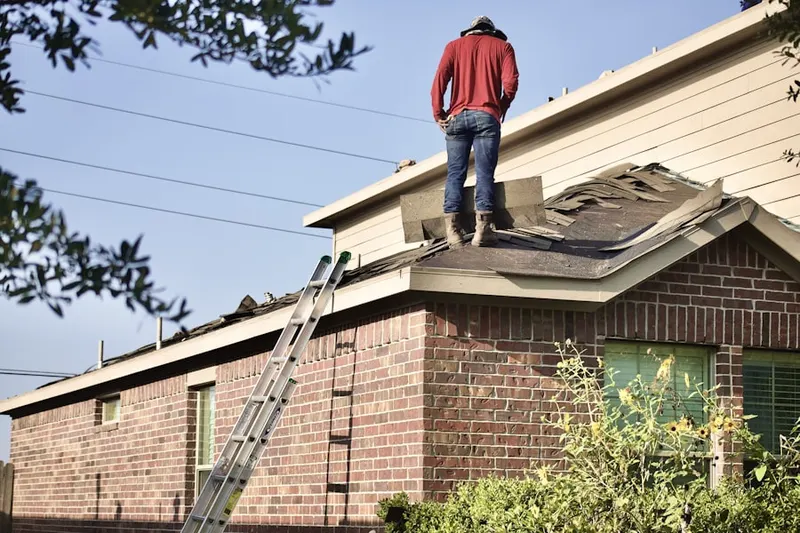 Professional roofer working on a residential roof in Redwood City